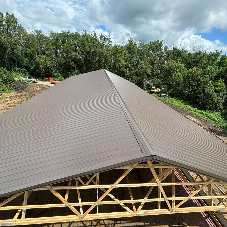 New steel roof panels over fresh trusses on a Murphy build