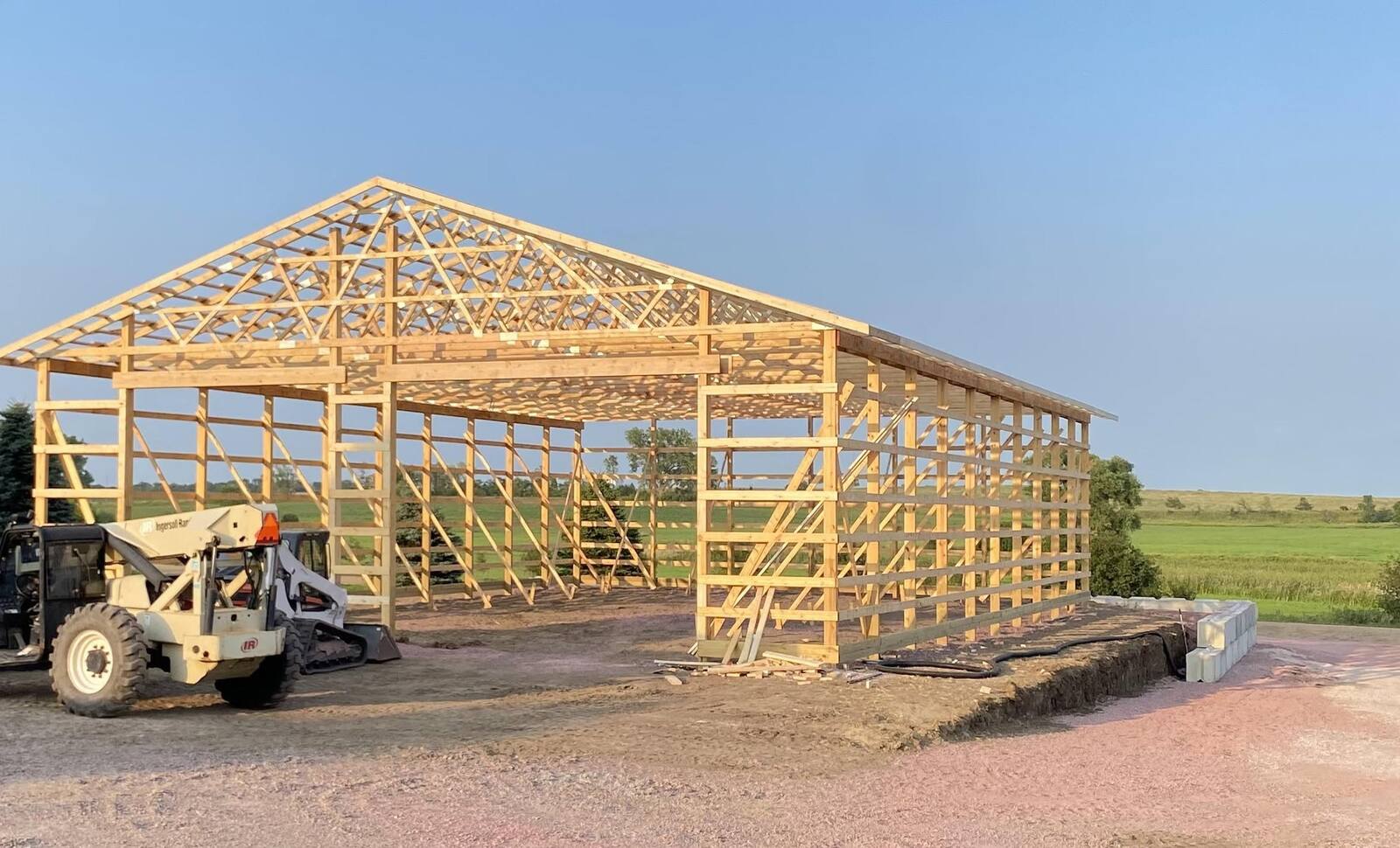 Pole shed truss framing going up on a Murphy Quality Work job site near Crooks, SD